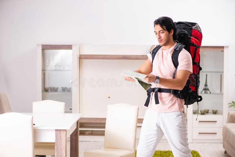 The Young Male Tourist Preparing for Trip at Home Stock Photo - Image ...