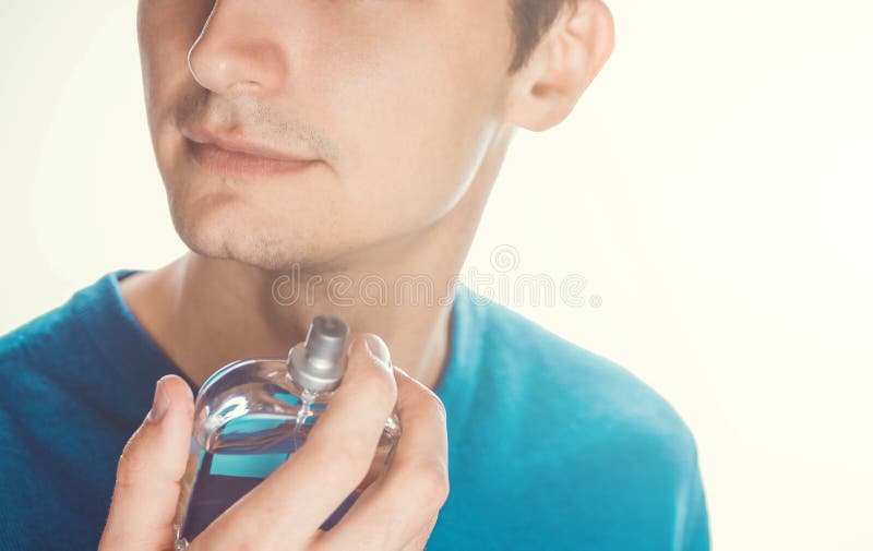 Young man applying perfume stock photo. Image of classic - 90452054