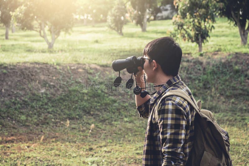 Young Man backpacking travel are using binoculars royalty free stock image Young Man backpacking travel are using binoculars royalty free stock image