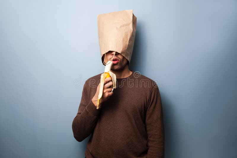 Young man eating banana stock image. Image of health 36025215