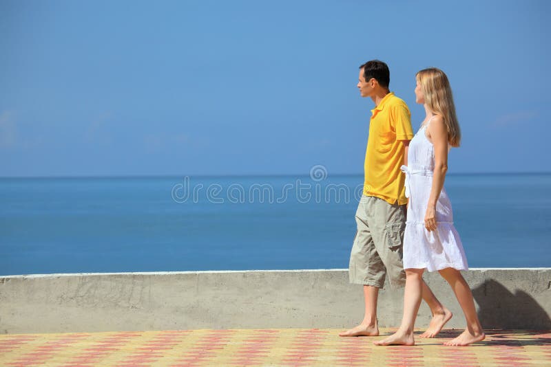Young man and beautiful woman on quay stock image