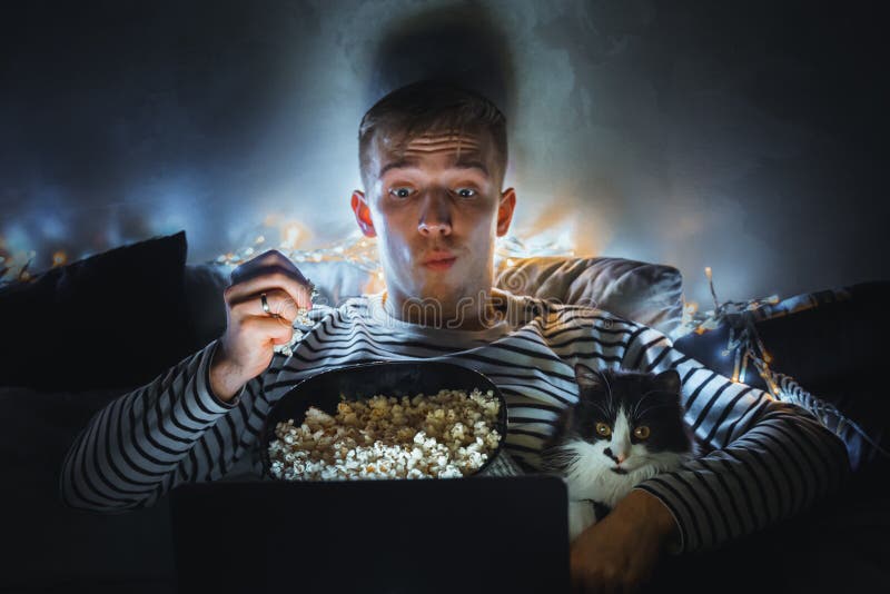 https://thumbs.dreamstime.com/b/young-man-black-cat-watching-movie-eating-popcorn-tv-home-movie-night-relax-rest-watching-horror-film-video-198570428.jpg