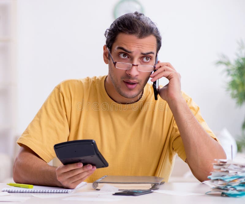 Young man in budget planning concept stock photo