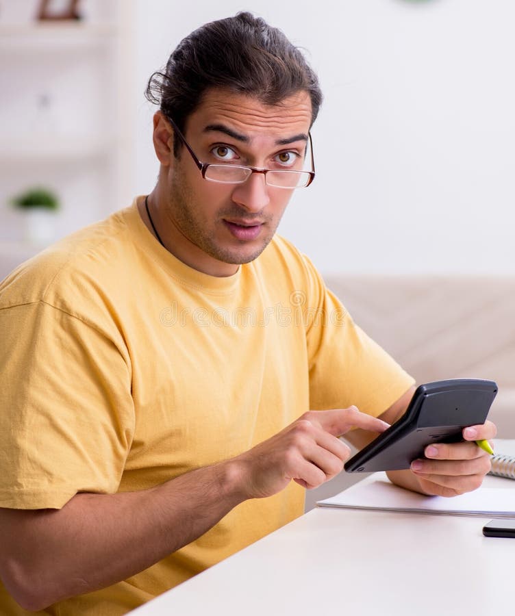 Young man in budget planning concept royalty free stock photo