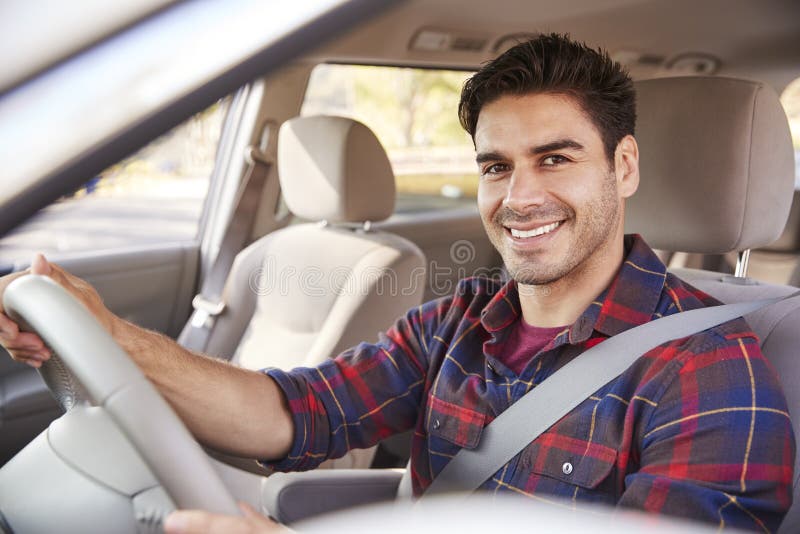 Young man in car driving seat looking to camera, portrait royalty free stock photography Young man in car driving seat looking to camera, portrait royalty free stock photography