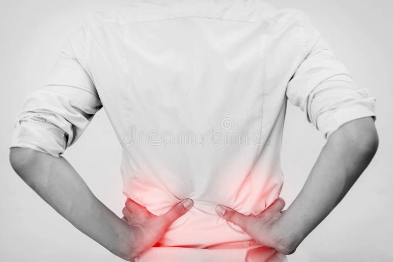 Young man in casual office shirt having hip pain stock images Young man in casual office shirt having hip pain stock images