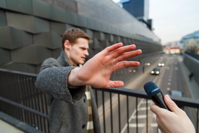 A young man is categorically against giving an interview to a journalist on the street.