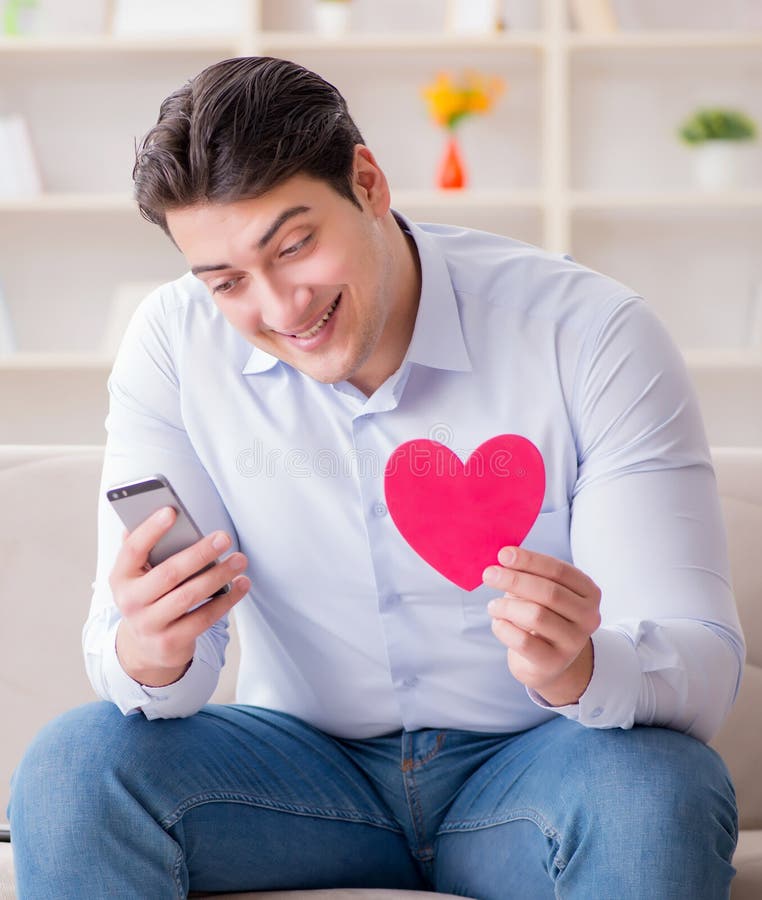 Young man chatting with his sweetheart over mobile phone stock photography Young man chatting with his sweetheart over mobile phone stock photography