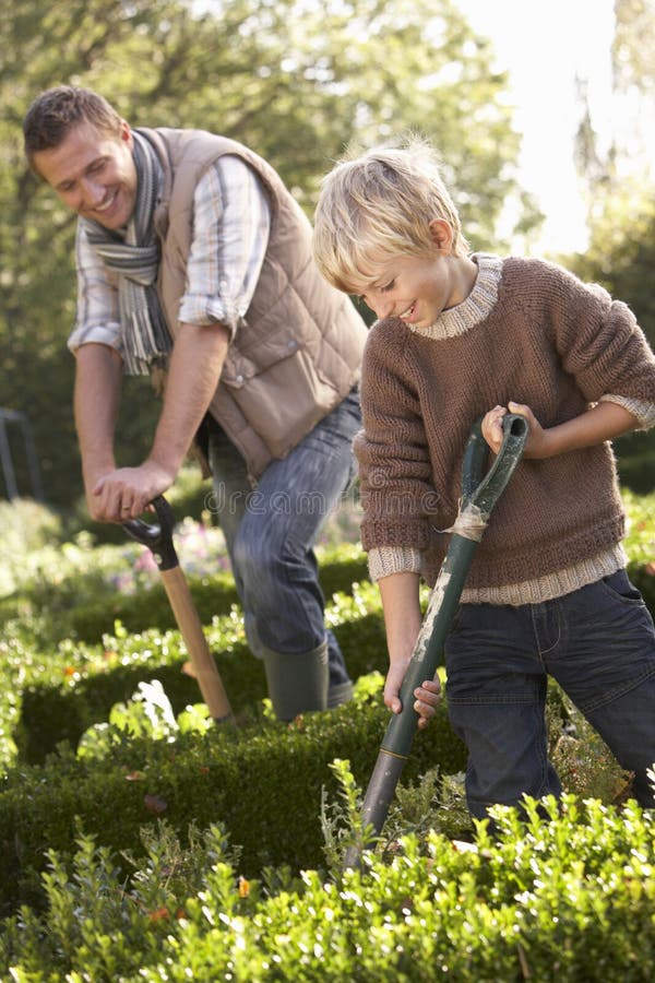 Young man with child working in garden