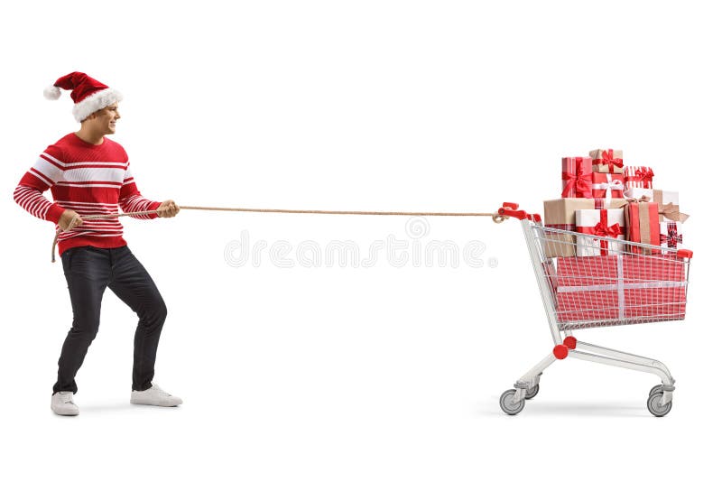 Young man with a christmas hat pulling a shopping cart full of presents with a rope royalty free stock photos Young man with a christmas hat pulling a shopping cart full of presents with a rope royalty free stock photos