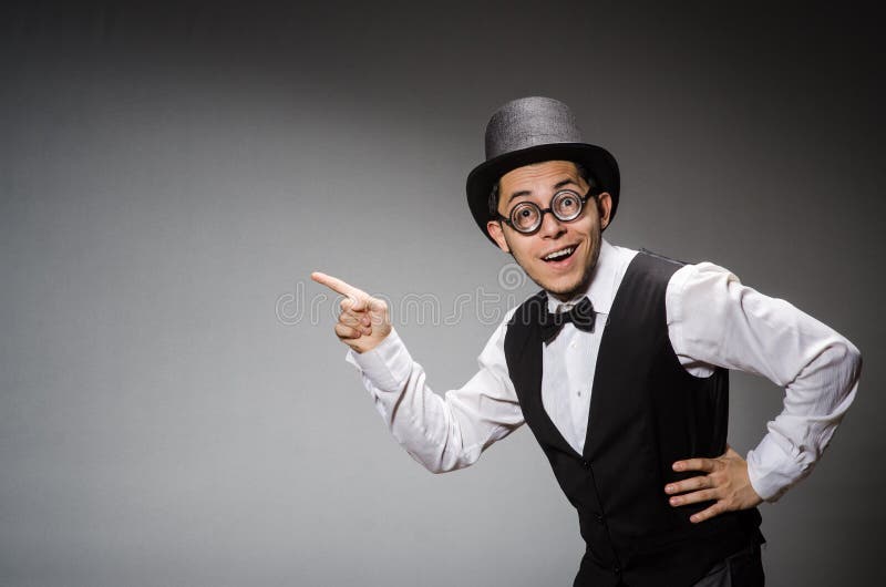 The young man in classical black vest and hat royalty free stock photography