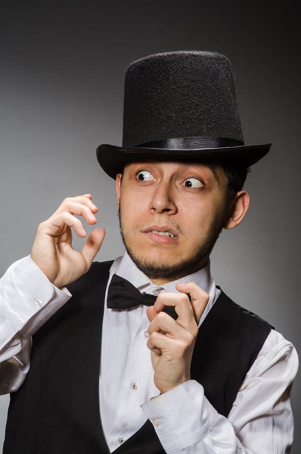 The young man in classical black vest and hat stock images