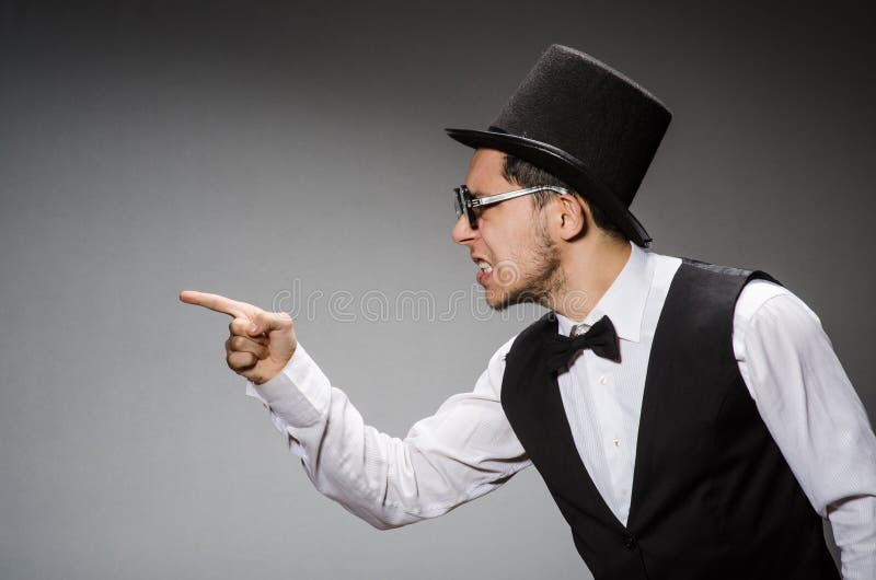 The young man in classical black vest and hat stock images