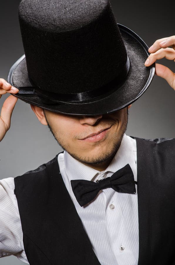 The young man in classical black vest and hat stock image
