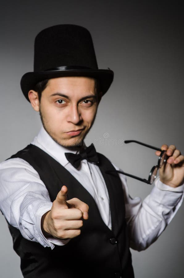 The young man in classical black vest and hat stock images