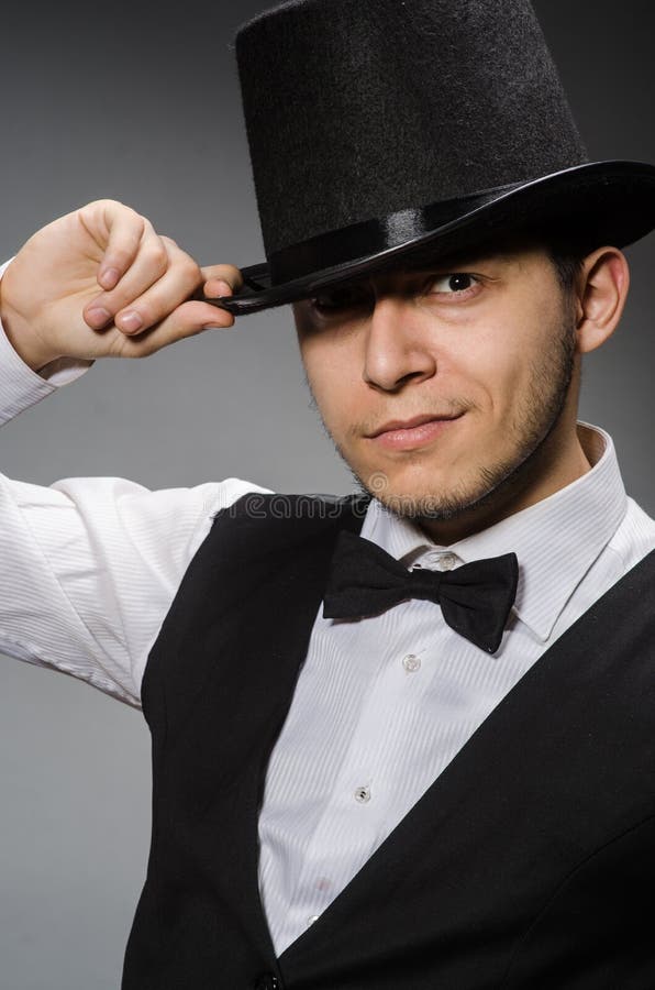 The young man in classical black vest and hat stock photos