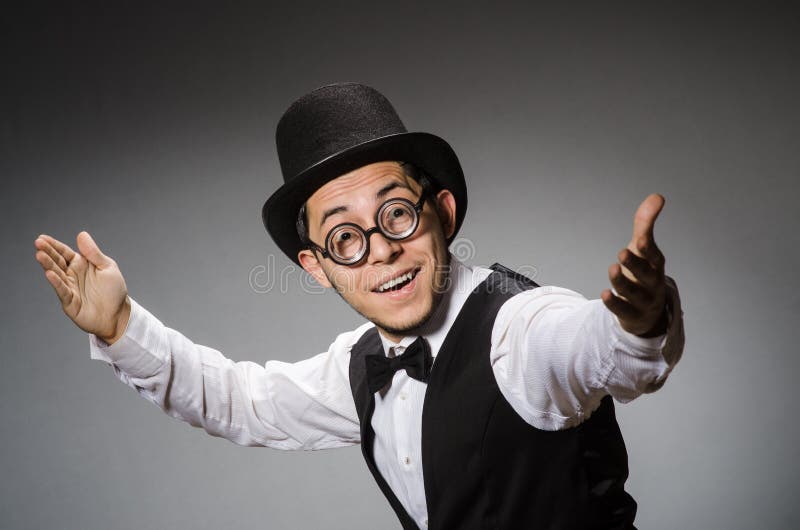 Young man in classical black vest and hat against royalty free stock photo