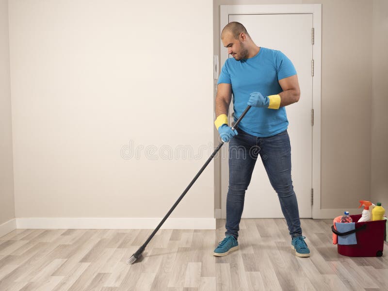 House cleaning. House cleaning man. House man sweeping and mopping