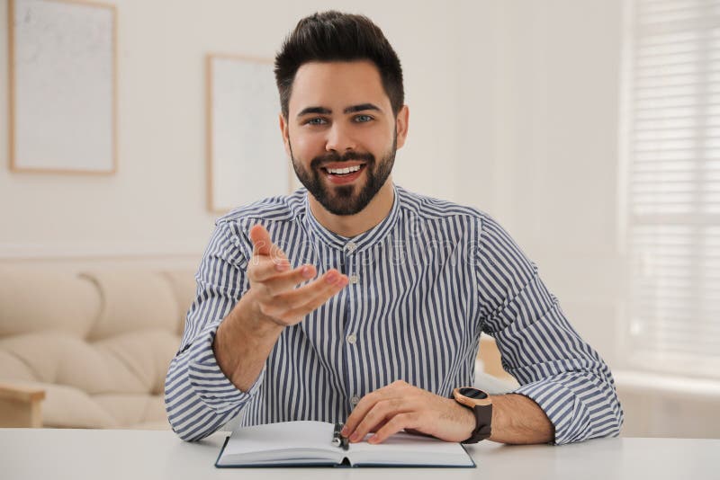 Young man conducting webinar at desk in room royalty free stock photo