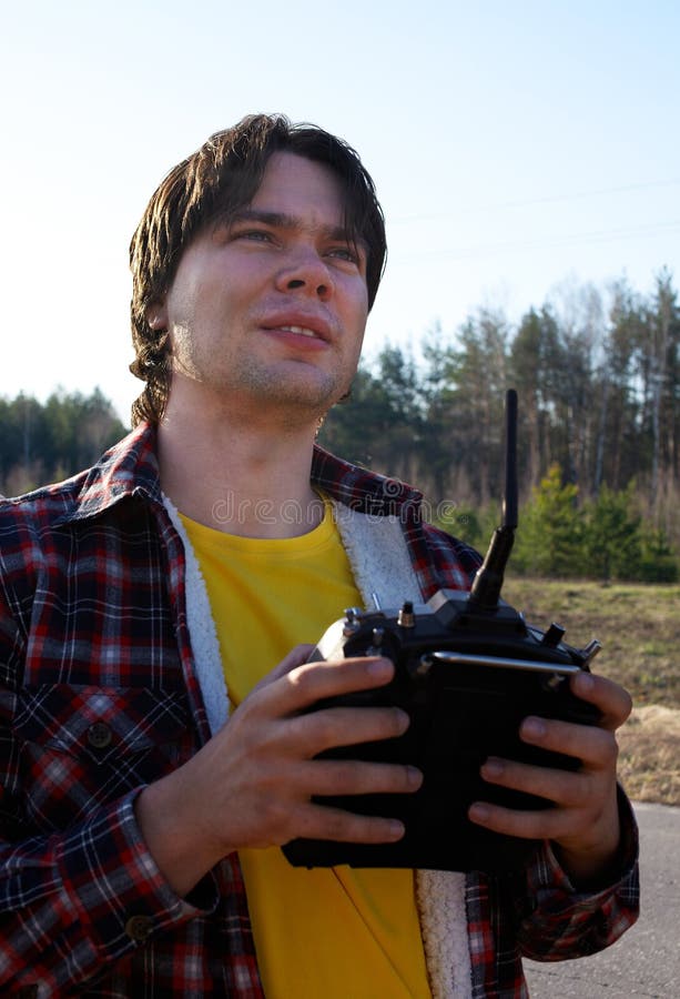 Young man controls RC plane in the sky royalty free stock photography Young man controls RC plane in the sky royalty free stock photography