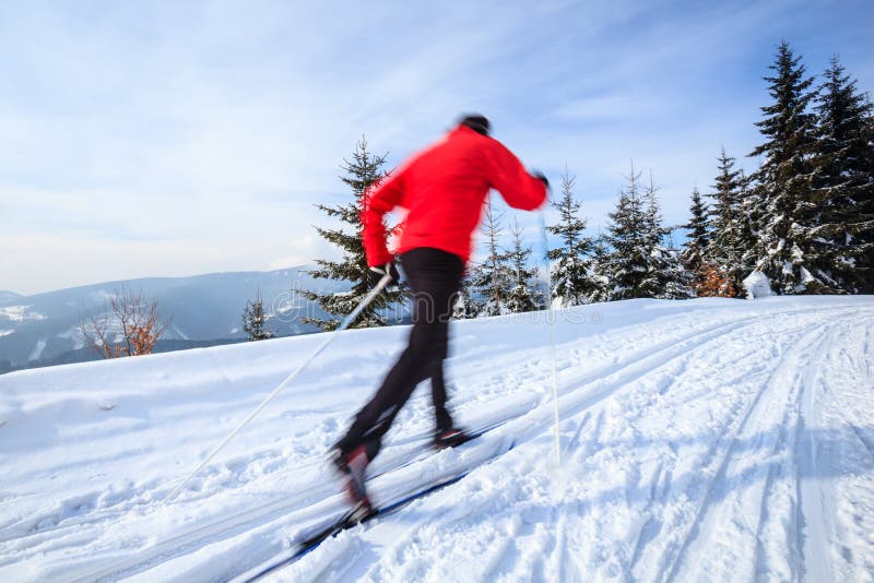 Cross-country skiing: young man cross-country skiing on a lovely sunny winter day (motion blur technique is used to convey movement). Exercise technique stock images, royalty-free photos and pictures