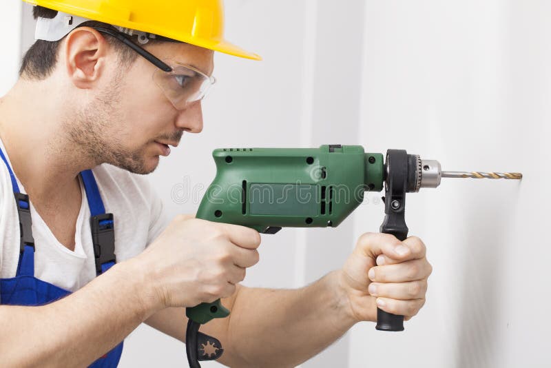 Young Man Drilling Hole In Wall Stock Photo Image Of Contractor
