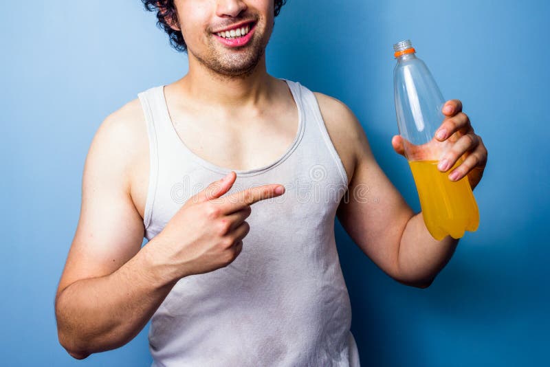 Young man drinking energy drink after a sweaty workout