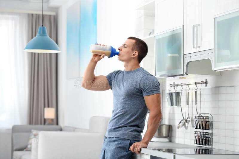 Young Man Drinking Protein Shake in Kitchen Stock Image Image of care