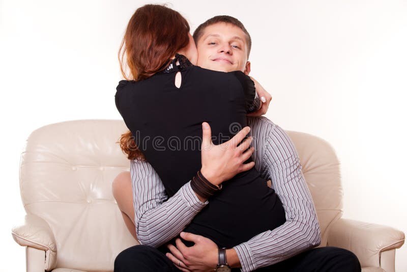 Young man embraces woman