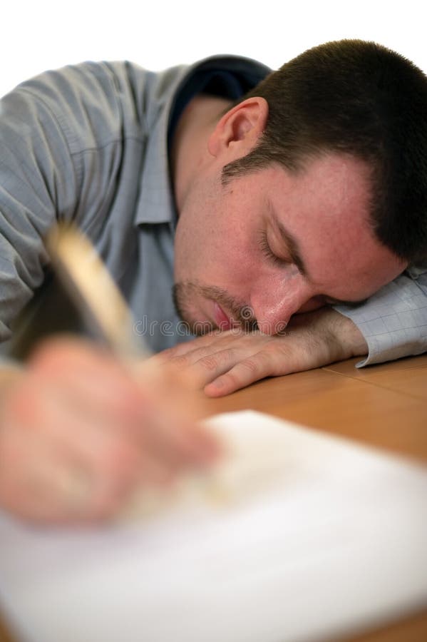 Young man at the office table, fell asleep while signing contracts. Shot focused on the eye, using very large aperture to minimize the depth of field for the effect. Young man at the office table, fell asleep while signing contracts. Shot focused on the eye, using very large aperture to minimize the depth of field for the effect
