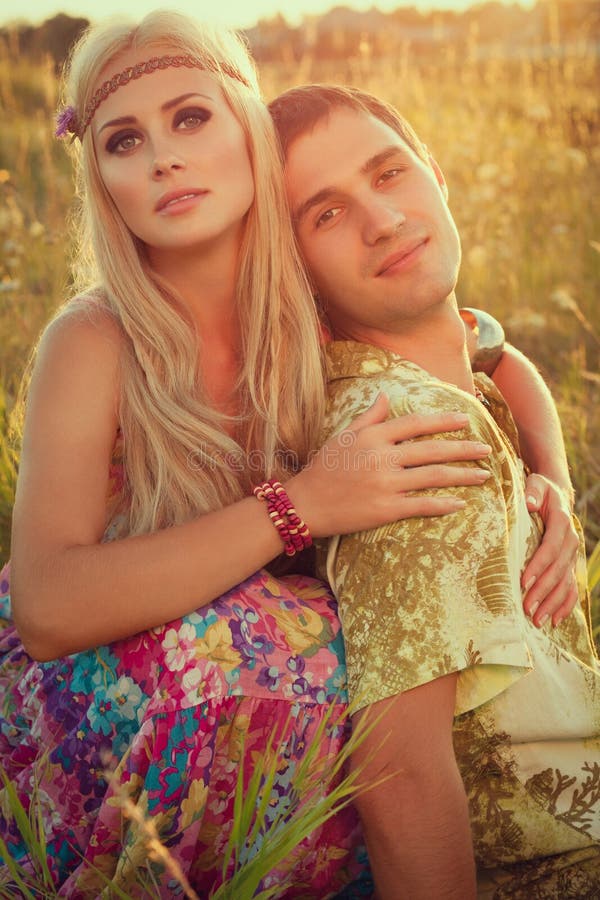 Young man and fine woman against sunset.