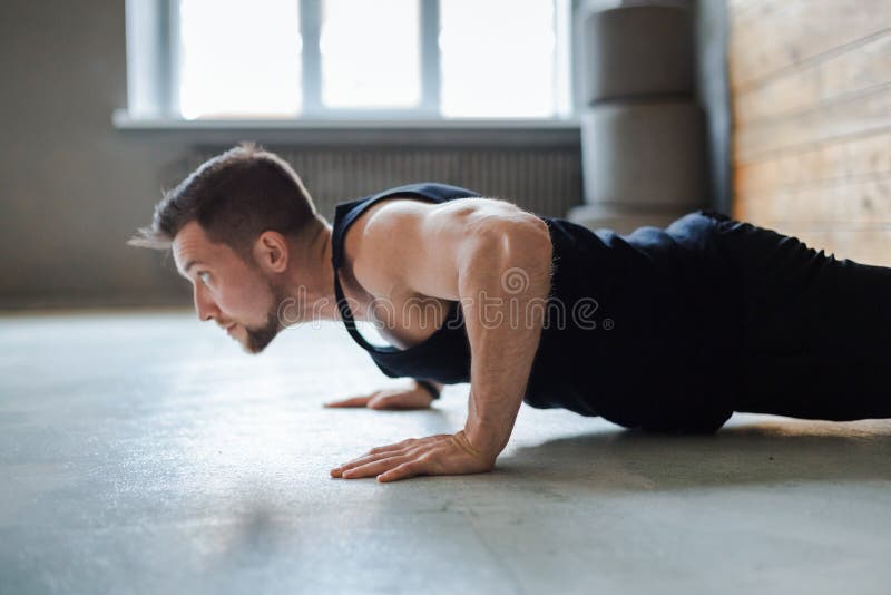 Young man fitness workout, push ups or plank