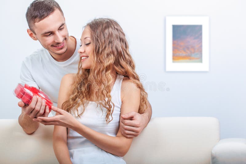 Young man gives her a heart shaped gift