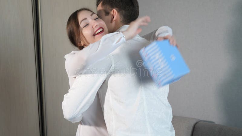 Young man in giving Valentine gift box to his girlfriend.