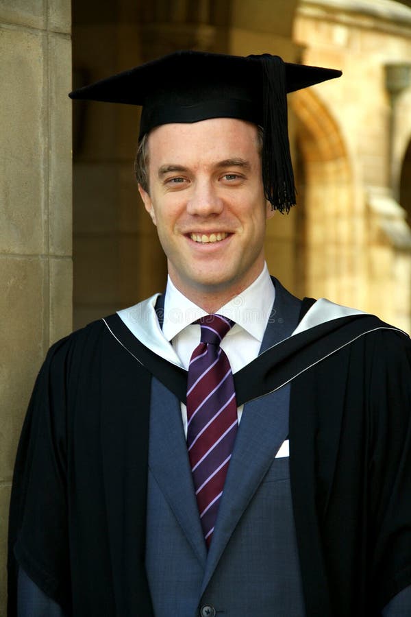 A young man in a graduation gown.