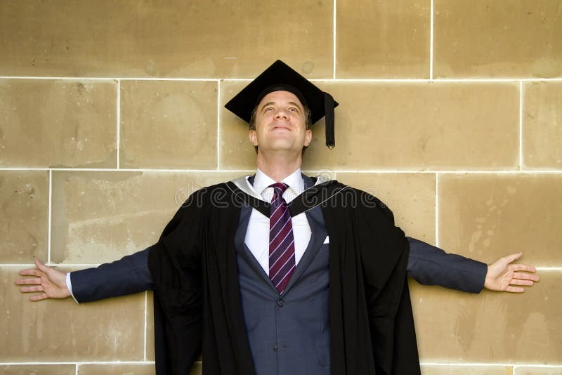 A young man in a graduation gown.