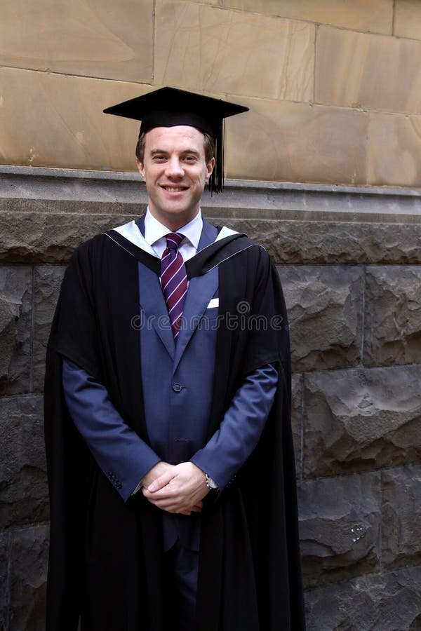 A young man in a graduation gown.