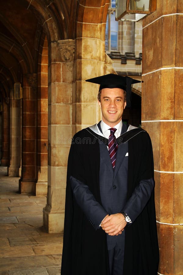 A young man in a graduation gown.