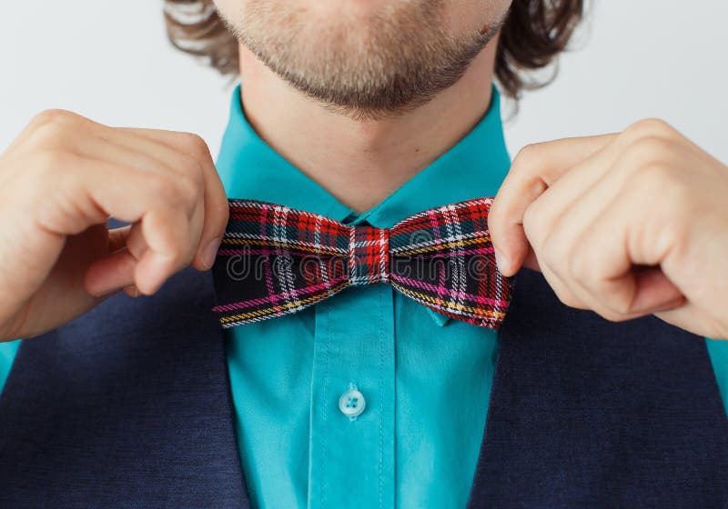 Young man in green shirt with beard in a bowtie stock photos Young man in green shirt with beard in a bowtie stock photos