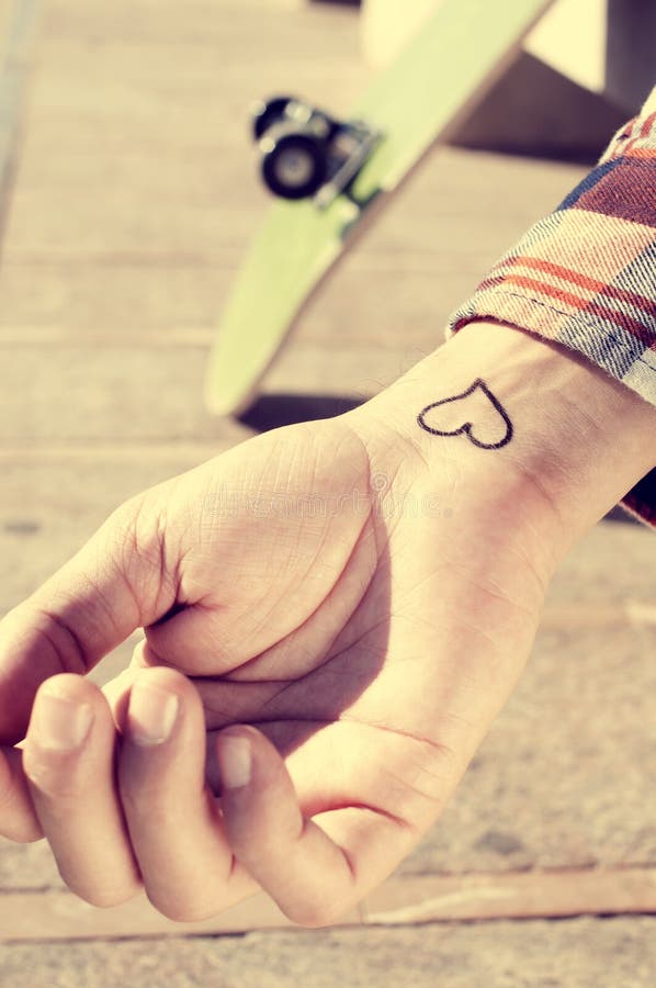 Closeup of the wrist of a young man with a heart in it, outdoors. Closeup of the wrist of a young man with a heart in it, outdoors