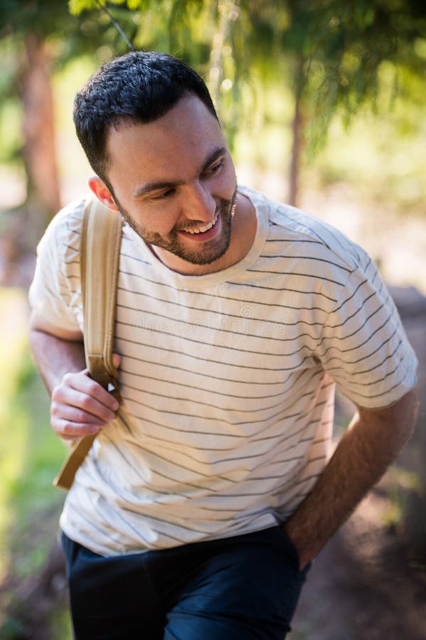 Young man hiking smiling happy portrait. Male hiker walking in forest royalty free stock photography Young man hiking smiling happy portrait. Male hiker walking in forest royalty free stock photography