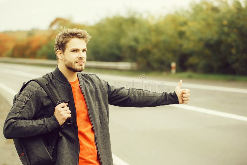 Young man hitchhiking stock image. Image of bearded, standing - 76571195