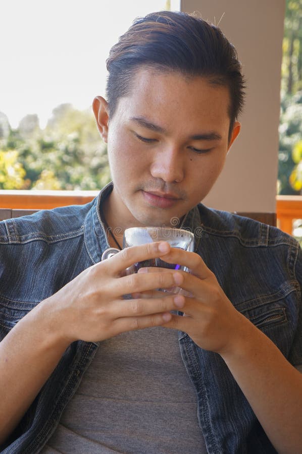 Young Man Holding Coffee Cup or Hot Tea Stock Photo - Image of coffee ...