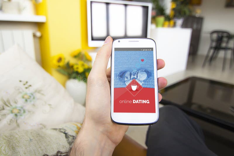 Young man holding mobile phone with online dating app on the screen royalty free stock photo Young man holding mobile phone with online dating app on the screen royalty free stock photo