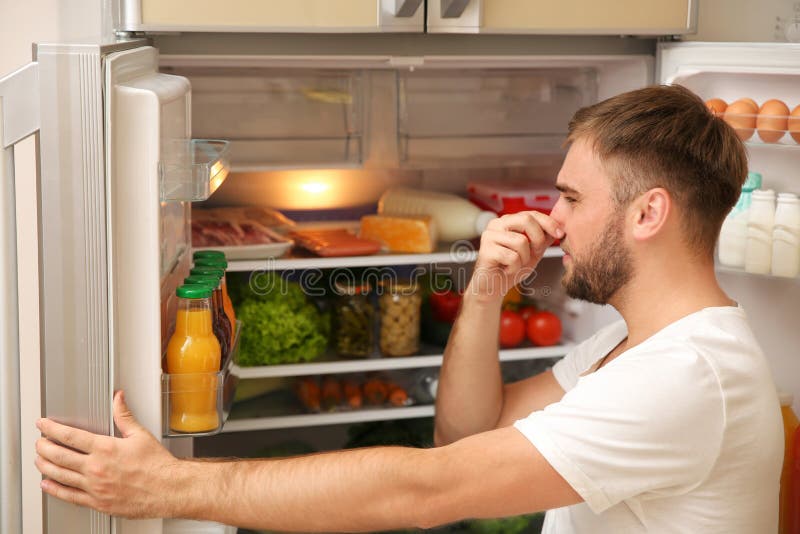 Young man holding nose cause of bad smell stock photography