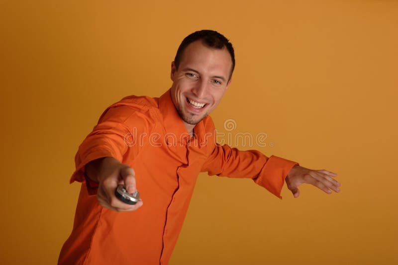 Young man holding a remote control royalty free stock photography