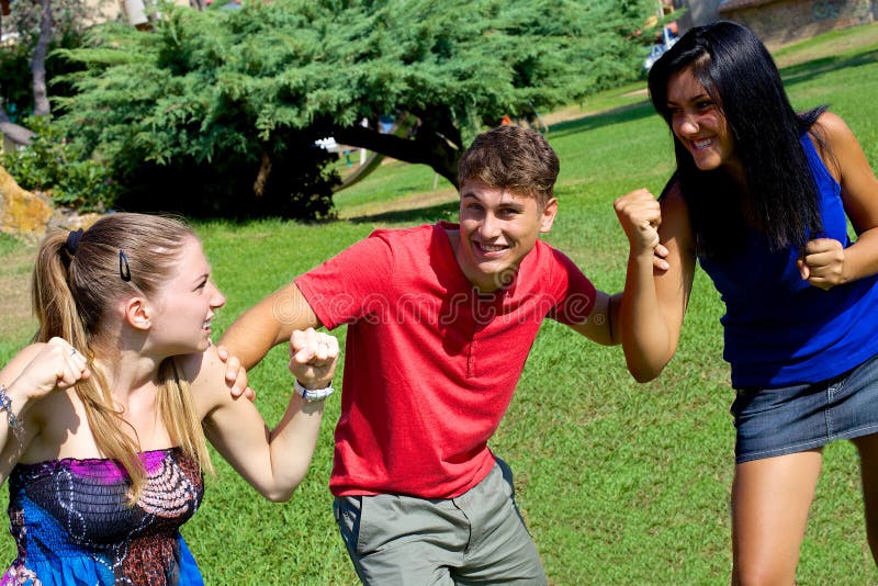Young Man Holding Two Girls Fighting For Him Stock Photo ...
