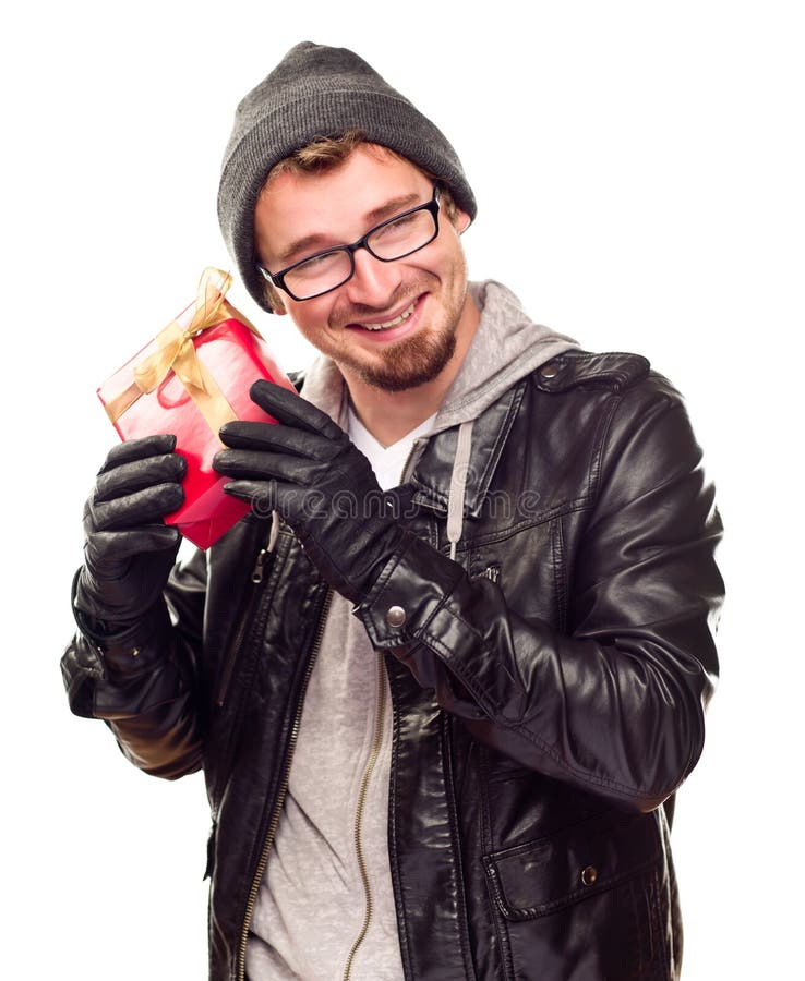 Young Man Holding Wrapped Gift To His Ear