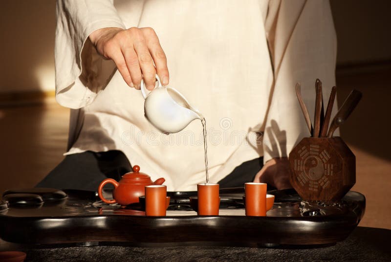 A young man holds a Chinese tea ceremony