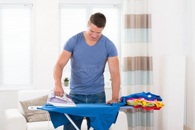 Young Man Ironing Clothes
